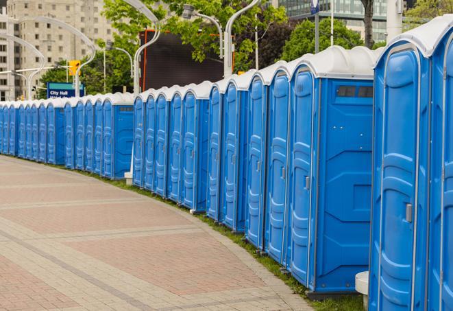 a line of portable restrooms at a sporting event, providing athletes and spectators with clean and accessible facilities in Jamaica Plain